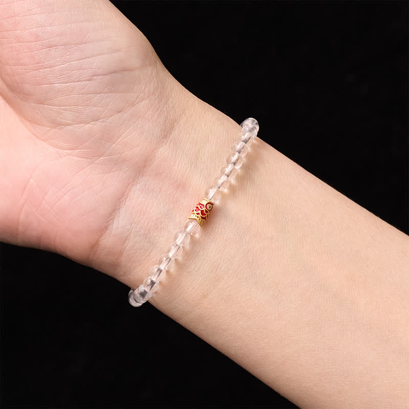 Clear Quartz Koi Fish Bracelet - clear crystal beaded bracelet worn on wrist, red gold accent