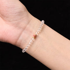 Clear Quartz Koi Fish Bracelet - clear crystal beaded bracelet worn on wrist, red gold accent