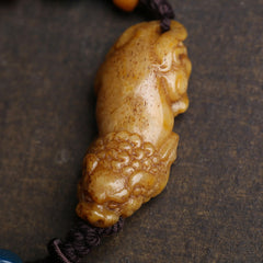 Bone PiXiu Braided Rope Bracelet – Side close-up of bone Pi Xiu carving, natural grain texture, traditional craft