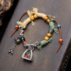 Copper Buddha Amitabha Bracelet – bracelet laid flat showing full length and charm, copper bracelet, Amitabha charm, rope