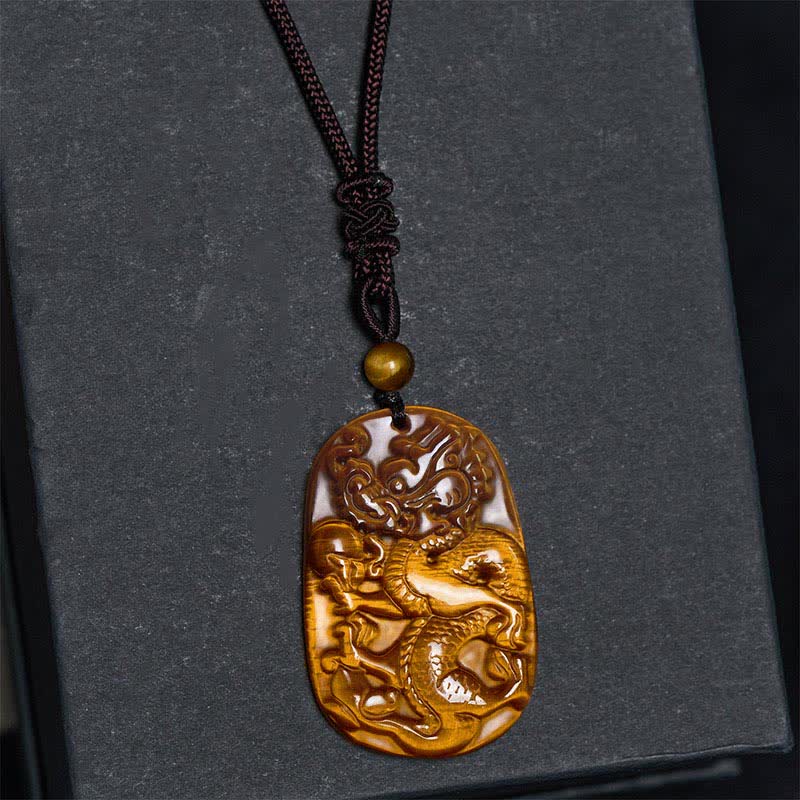 Tiger Eye Carved Dragon Rope Protection Necklace – close-up amber dragon carving with ruyi cloud patterns, luck
