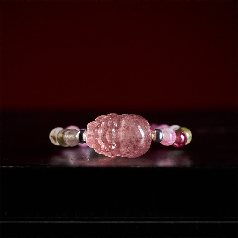 3mm PiXiu Gemstone Ring – Front view of PiXiu with tourmaline beads on dark red background, shiny