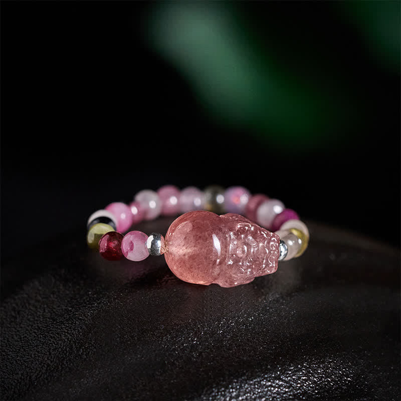 3mm PiXiu Gemstone Ring – Side angle of tourmaline bead ring with PiXiu on dark surface, crystals