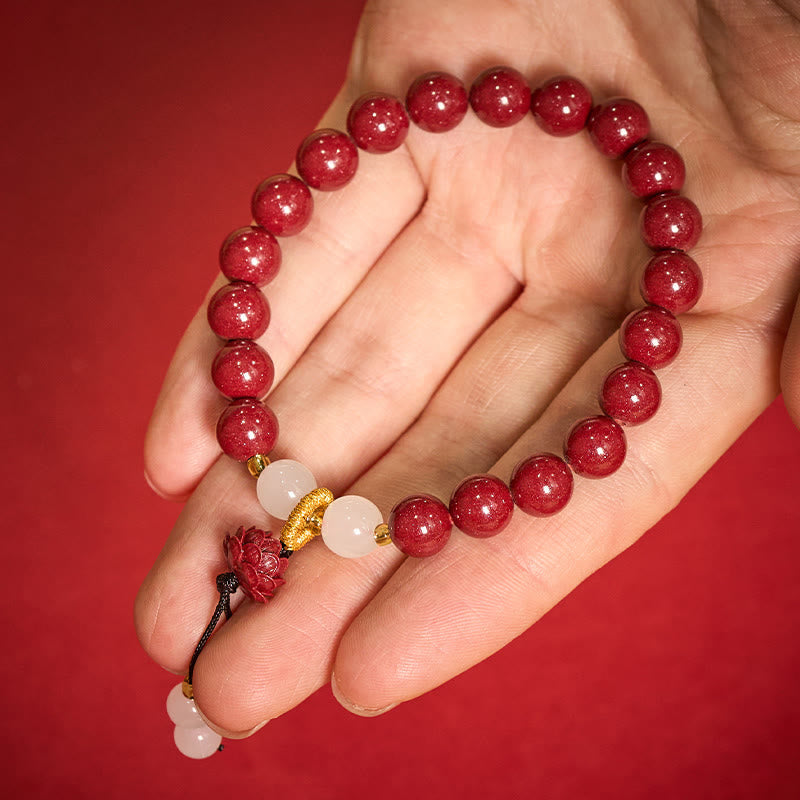 Cinnabar Lotus Enlightenment Bracelet – palm view highlighting white jade gourd charm below lotus, red cinnabar beads, fortune bracelet
