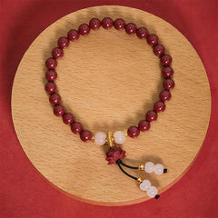 Cinnabar Lotus Enlightenment Bracelet – full circle on wood disc with carved lotus pendant, red backdrop, cinnabar bracelet