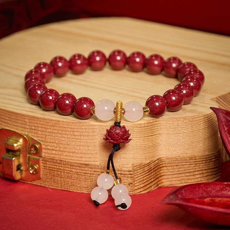 Cinnabar Lotus Enlightenment Bracelet – in carved wood bowl surrounded by woven fiber mat, gourd pendant visible, good luck amulet