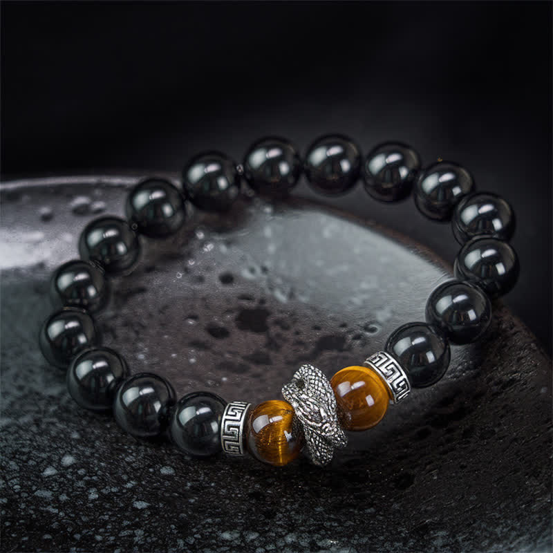 Silver Sheen Obsidian Red Tiger Eye Dragon Success Bracelet - on wrist close-up dragon head amber beads black backdrop, po...