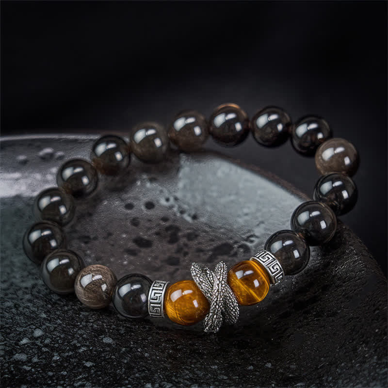 Silver Sheen Obsidian Red Tiger Eye Dragon Success Bracelet - dark moody flat lay with silver dragon focal detail, luxurious