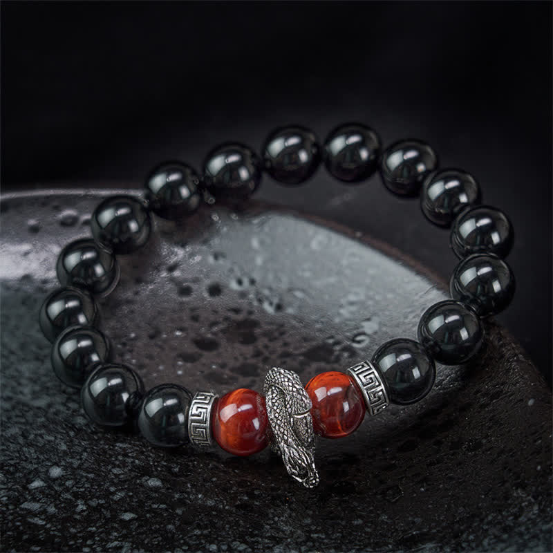 Silver Sheen Obsidian Red Tiger Eye Dragon Success Bracelet - low angle on dark stone dragon with red beads, majestic