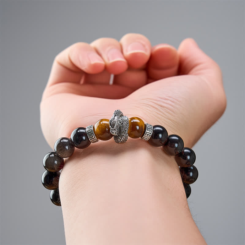 Silver Sheen Obsidian Red Tiger Eye Dragon Success Bracelet - on wrist neutral gray background with red tiger eye glow, pr...