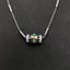 Evil Eye Pendant Necklace – Cylindrical evil eye bead with turquoise eyes on braided silver chain