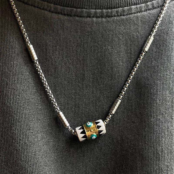 Evil Eye Pendant Necklace – Barrel pendant with dual nazar charms on dark knit shirt, worn lifestyle shot