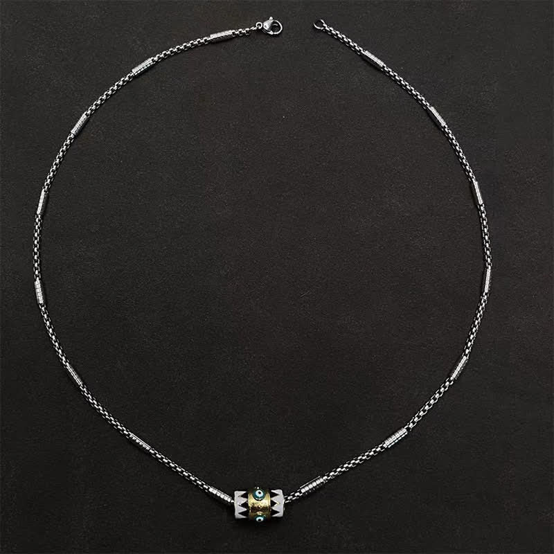 Evil Eye Pendant Necklace – Circular layout of copper enamel pendant necklace on matte black, evil eye detail