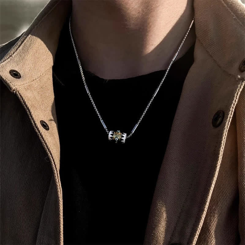 Evil Eye Pendant Necklace – Evil eye barrel pendant with gold center on tan jacket, men's protection jewelry