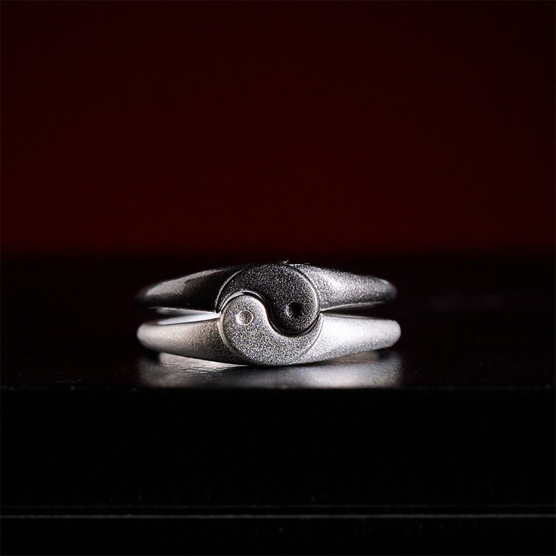 Yin Yang Copper Ring - Interlocking silver bands forming yin-yang symbol on black surface, couples rings