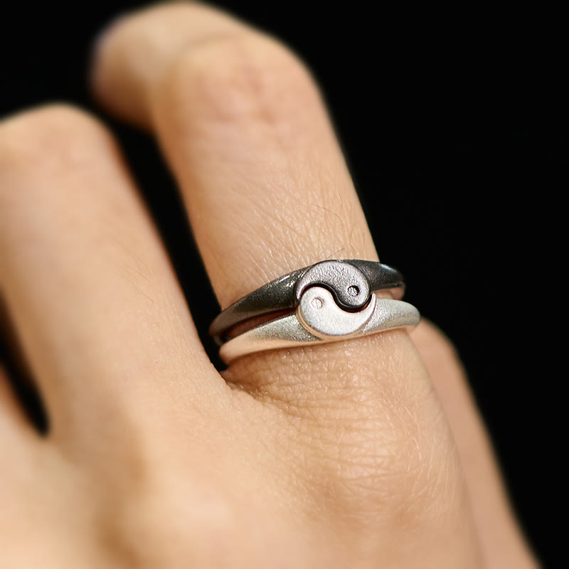 Yin Yang Copper Ring - Close-up yin-yang ring on finger, matte dark and polished silver halves
