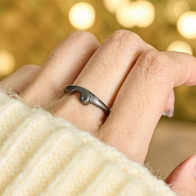 Yin Yang Copper Ring - Dark oxidized ring on hand with warm bokeh, cozy sweater lifestyle shot