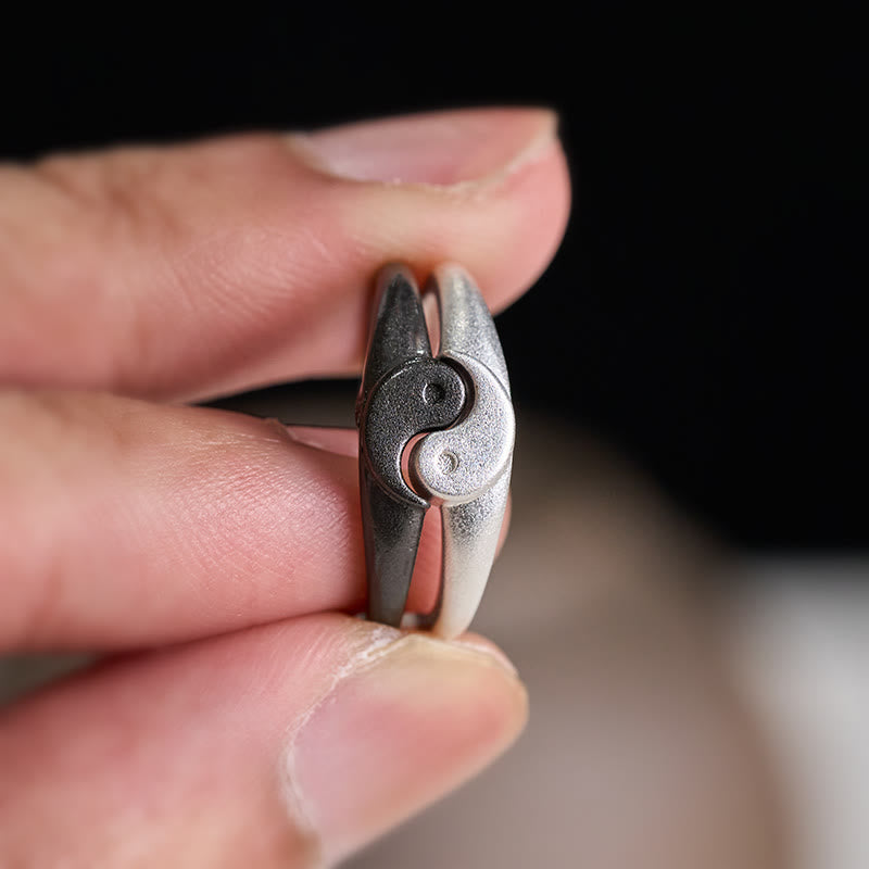 Yin Yang Copper Ring - Split puzzle rings held in hand showing yin-yang separation, oxidized silver