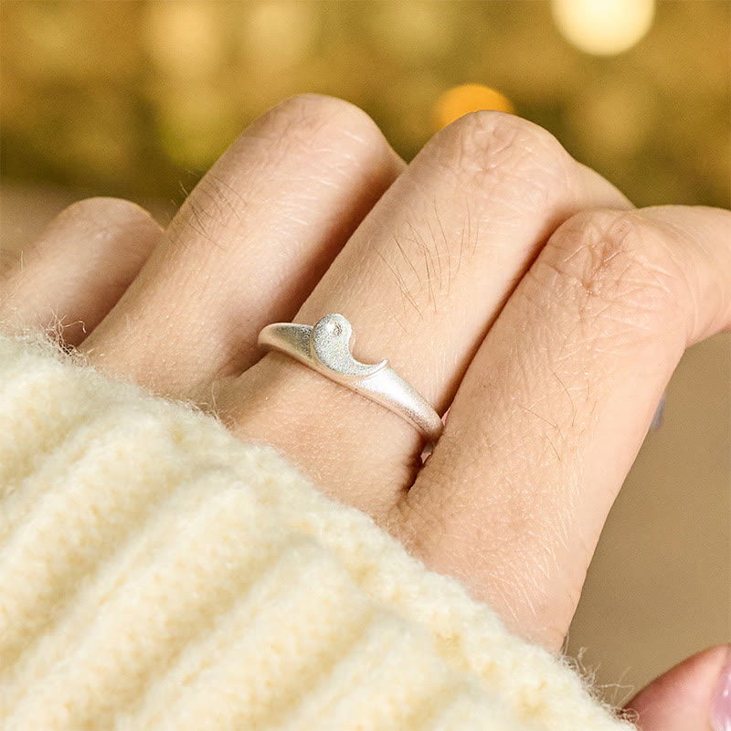 Yin Yang Copper Ring - Wave-motif ring worn on hand with golden bokeh, knit sweater ocean ring