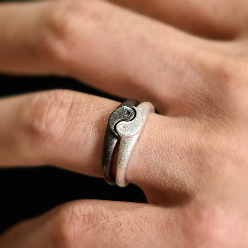Yin Yang Copper Ring - Close-up yin-yang ring on finger, dark background, symbolic couples jewelry