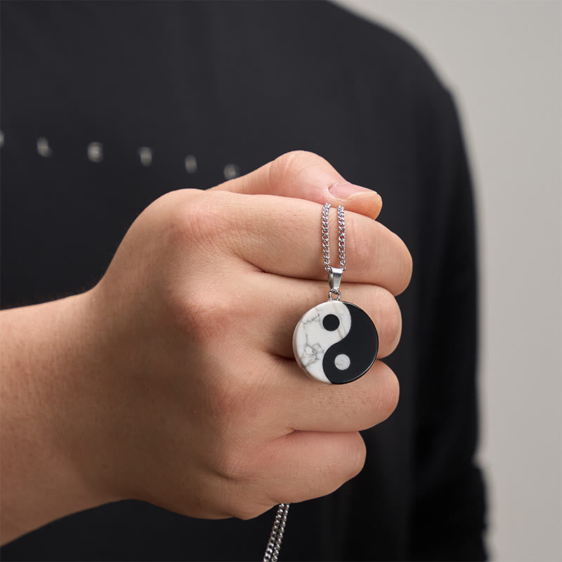 Yin Yang Obsidian Necklace - hand-held shot of stone pendant showing scale, balance necklace