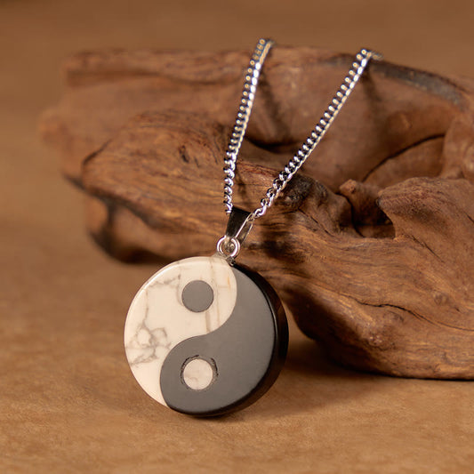 Yin Yang Obsidian Necklace - close-up of polished stone pendant with gray veining, healing crystal