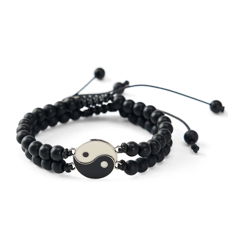 Hematite Lava Rock Yin Yang Bracelet - Black beaded bracelet on wrist with yin-yang charm, wellness lifestyle