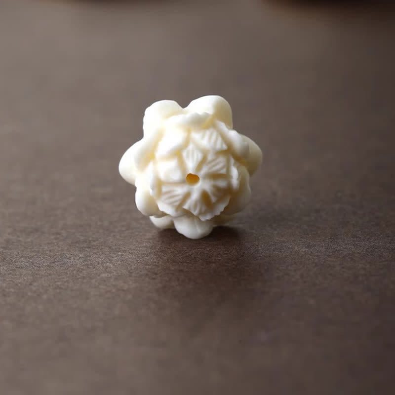 Rainbow Obsidian Lotus Peace Buckle Keychain - macro of hand-carved ivory lotus bead, artisan detail
