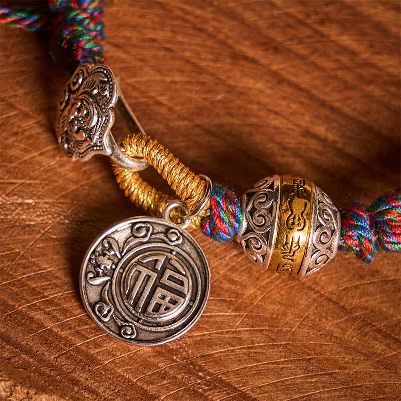Fu Swastika Rope Bracelet - Red braided cord bracelet with silver gold beads and Fu character pendant on beige felt, adjustable bracelet