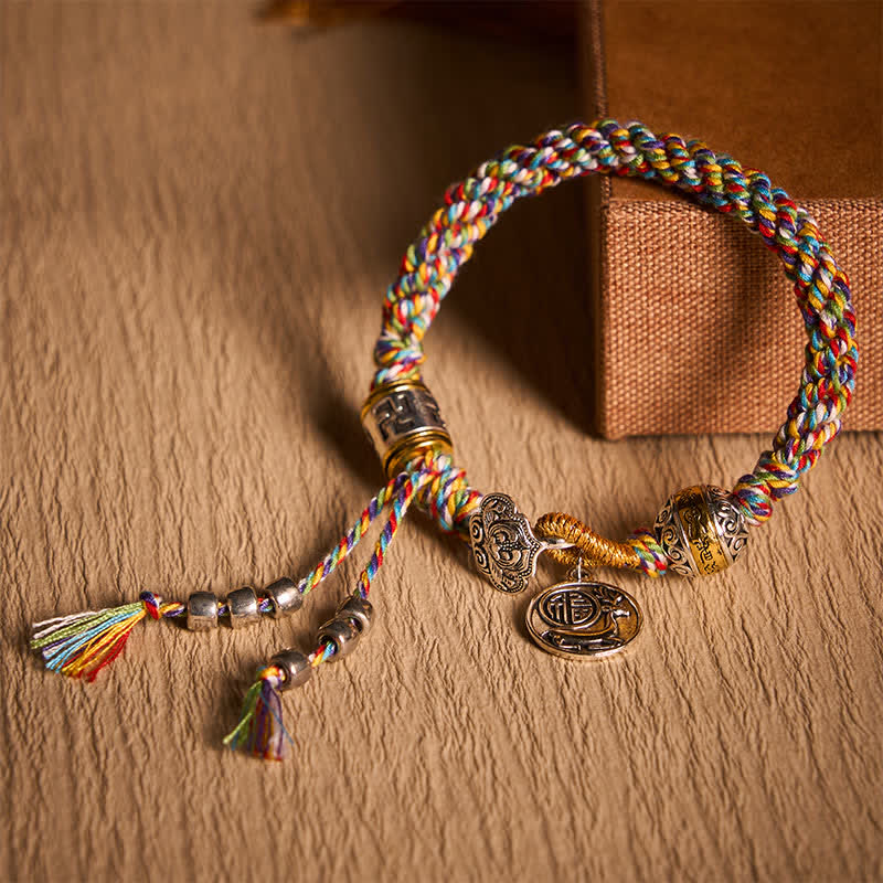 Fu Swastika Rope Bracelet - Green braided rope bracelet with Tibetan Buddhist prayer wheel charm featuring fortune symbol, spiritual jewelry