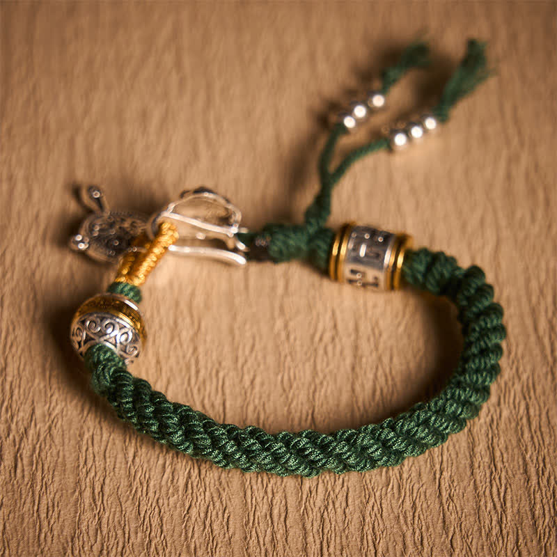 Fu Swastika Rope Bracelet - Tibetan mala bracelet with silver lotus charm, sacred script medallion and gold beads on green cord, prayer jewelry