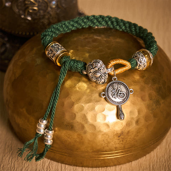 Fu Swastika Rope Bracelet - Tibetan Buddhist bracelet with antique silver lotus bead, green cord and gold accent charms, handcrafted prayer jewelry