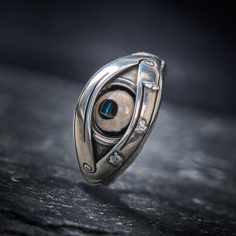 Dzi Evil Eye Ring – Antiqued silver eye ring with blue pupil stone on dark slate, protection ring