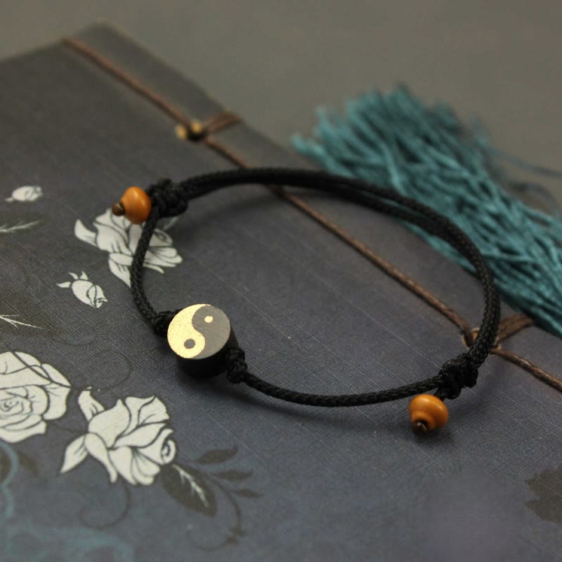 Ebony Yin Yang String Bracelet – black cord yin yang bead on floral journal, adjustable bracelet