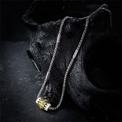 Evil Eye Pendant Necklace – Dual-tone barrel pendant with blue eye on volcanic rock, protective amulet