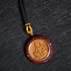 Sandalwood Jambhala Tara Necklace – necklace on black velvet showing pendant, sandalwood necklace, Jambhala pendant, Tara
