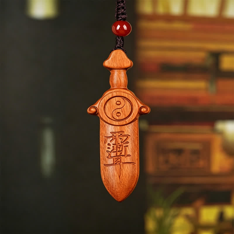 Yin Yang Sword Keychain - Traditional Chinese wooden sword pendant with yin-yang symbol and talisman carving, red bead on bla