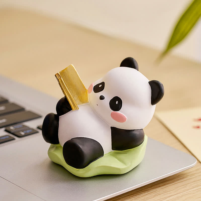 Resin Lotus Panda Phone Stand – Reclining panda holding gold bar on laptop keyboard, functional phone holder desk accessory