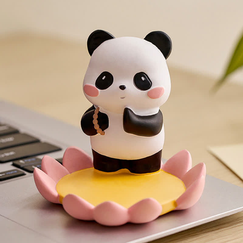 Resin Lotus Panda Phone Stand – Meditating panda on pink lotus base placed on laptop keyboard, zen desk accessory lifestyle