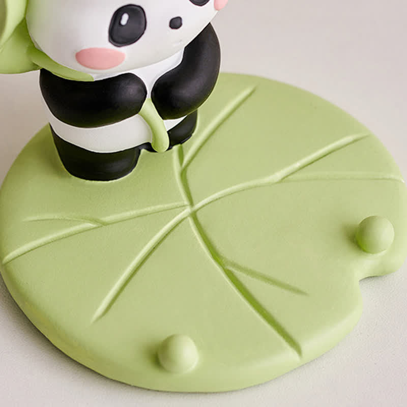 Resin Lotus Panda Phone Stand – Standing panda with green lotus leaf umbrella on lily pad base, side angle view, nature th...