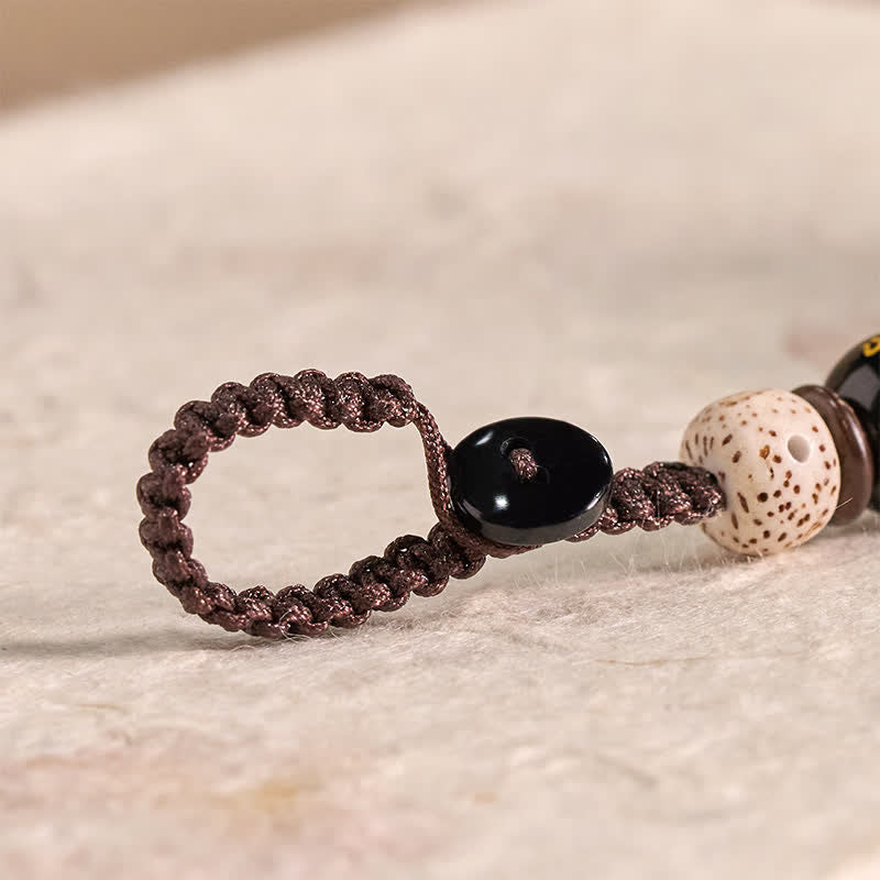 Wood Cat Keychain - Braided cord loop with Bodhi seed bead, black mantra bead, craft detail shot