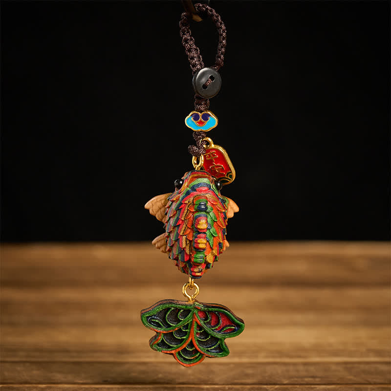 Rainbow Eucalyptus Koi Fish Keychain – multicolor koi fish pendant with layered scales on black and wood background