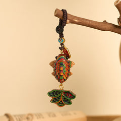 Rainbow Eucalyptus Koi Fish Keychain – multicolor koi fish pendant on wooden branch with braided cord, cream background