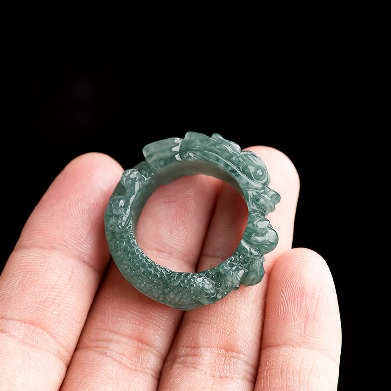 Natural Jade Dragon Ring - Coiled dragon ring held on fingers against black, Success