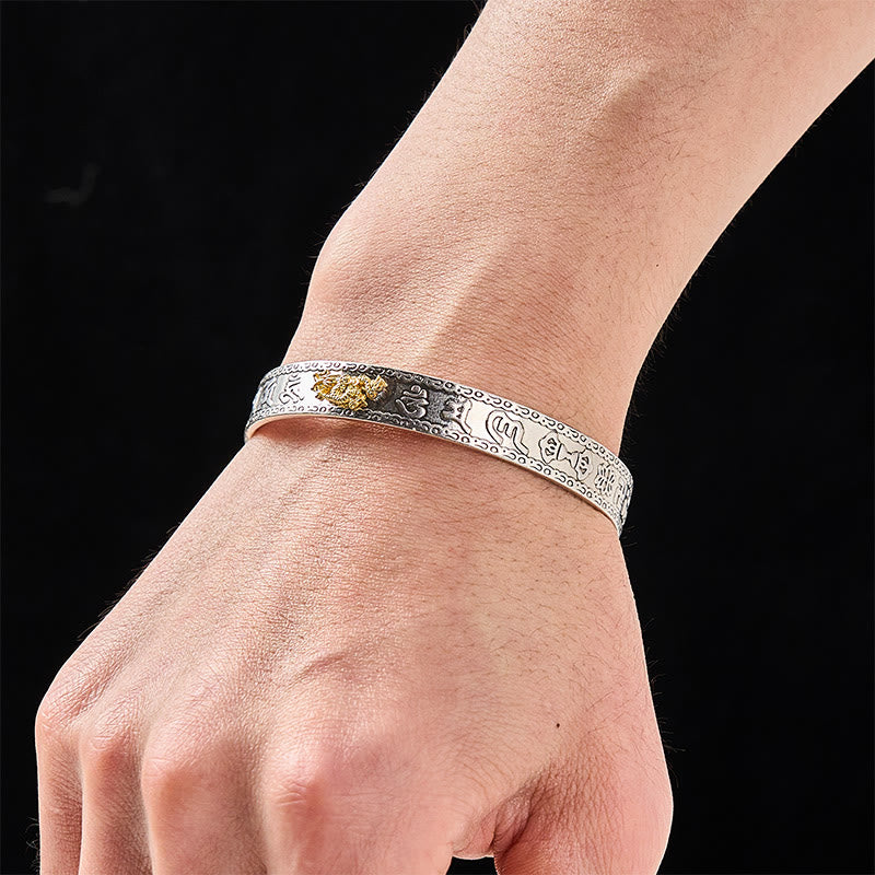 PiXiu Dragon Lotus Silver Bracelet – Gold dragon silver cuff worn on wrist, black background, wealth