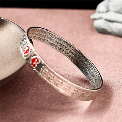 PiXiu Dragon Lotus Silver Bracelet – Close-up gold dragon charm on silver cuff bracelet, good luck