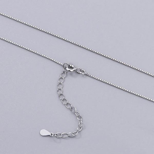 Zen Cairn Crystal Pendant – silver box chain with lobster clasp on gray background, adjustable necklace