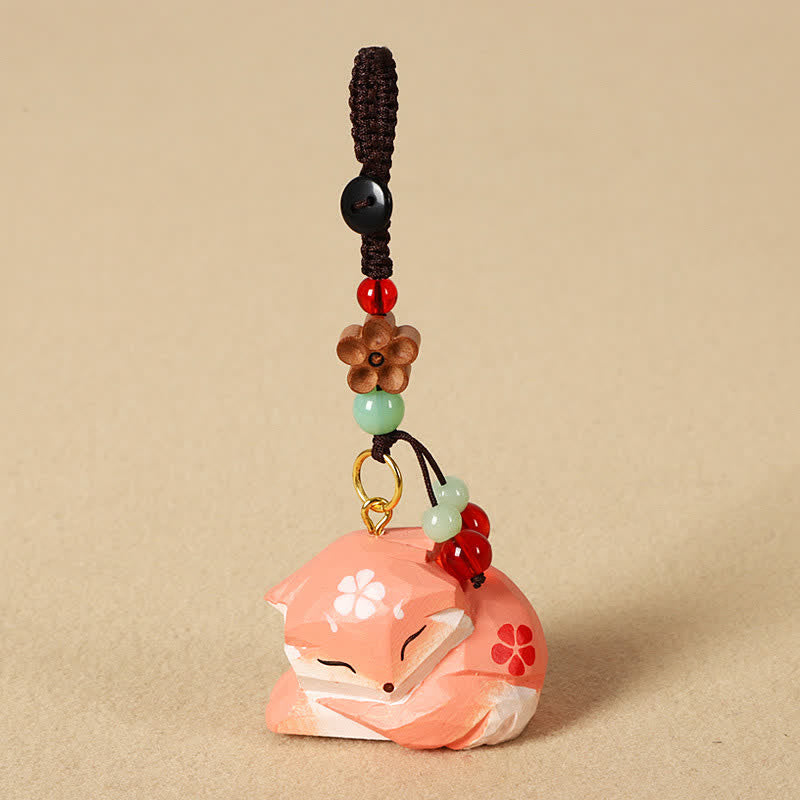 Wood Fox Keychain – Peach-pink sleeping fox with cherry blossom, red and green bead accents, handmade charm