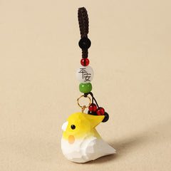 Hand-Carved Wood Cockatiel Om Mani Padm… – Bird keychain with peace blessing bead, red berry dangle, and braided cord, handc…