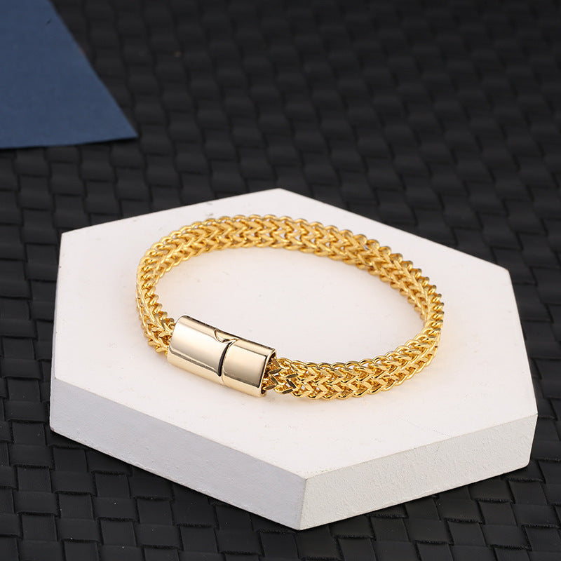 Fish Scale Titanium Steel Magnetic Bracelet – gold-plated double chain on hexagonal pedestal, dark woven background, warm tone
